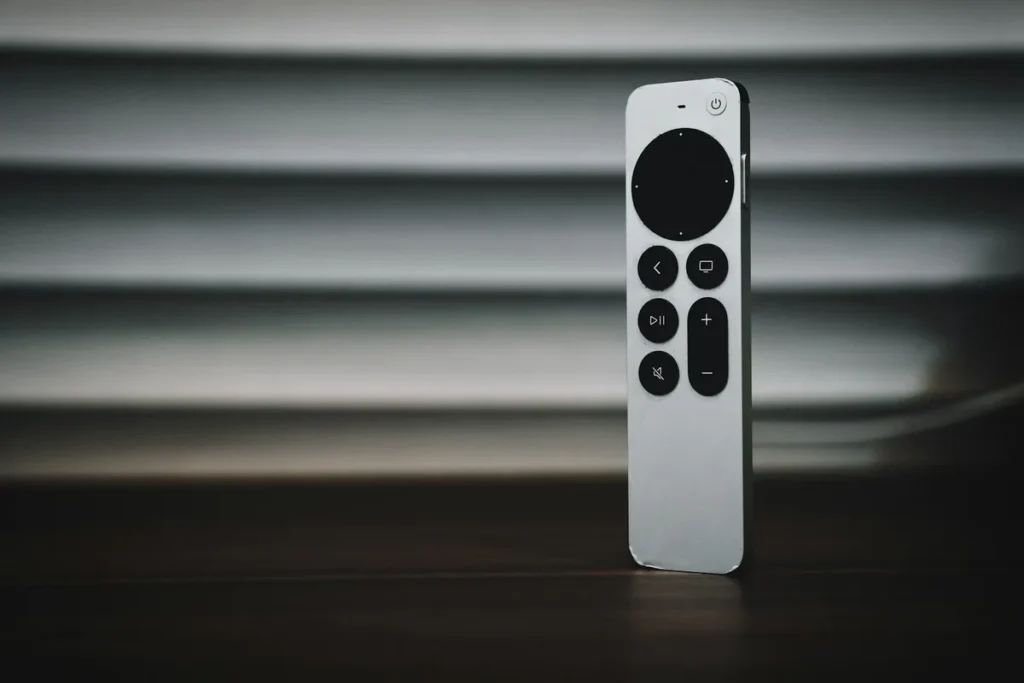 Silver Siri Remote with a circular clickpad, the remote supplied with recent Apple TV box models