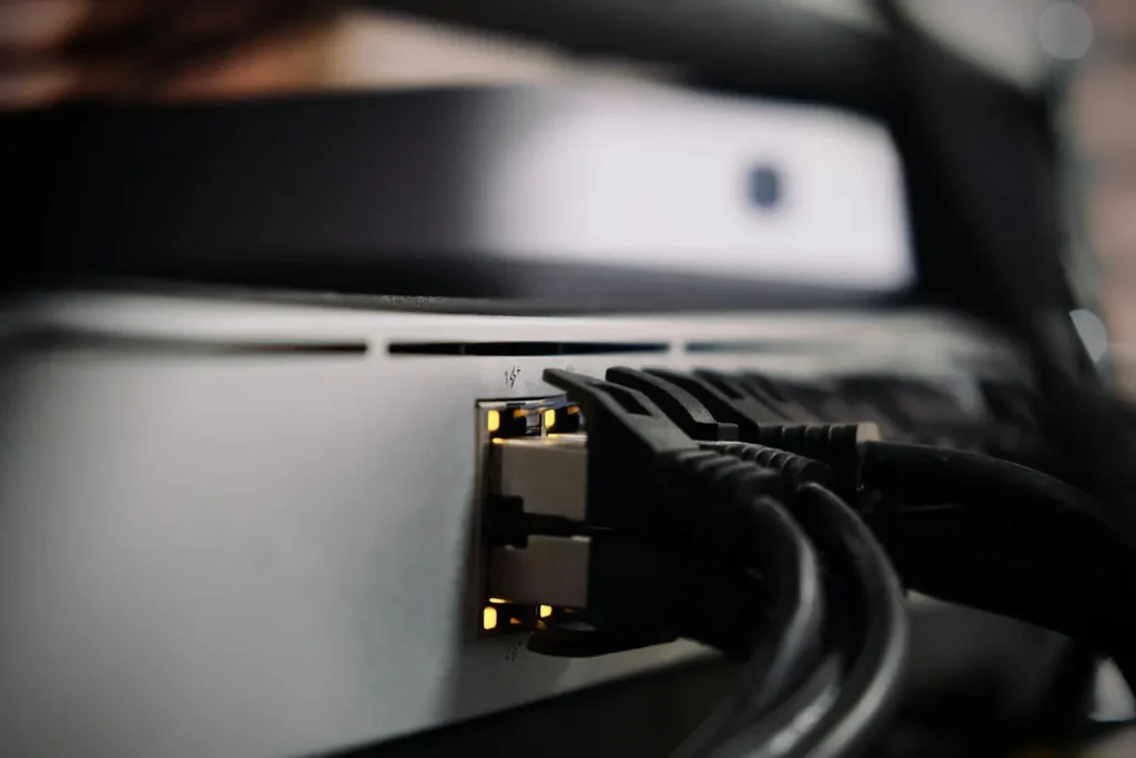 Ethernet cables plugged into a home network switch, the wired connection an Android TV box needs for stable live TV