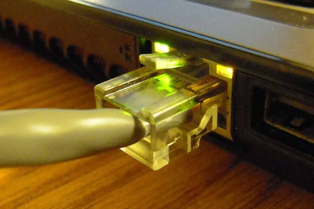 Ethernet cable plugged into a network port with link lights on, the quickest way to test whether IPTV buffering is a Wi-Fi problem