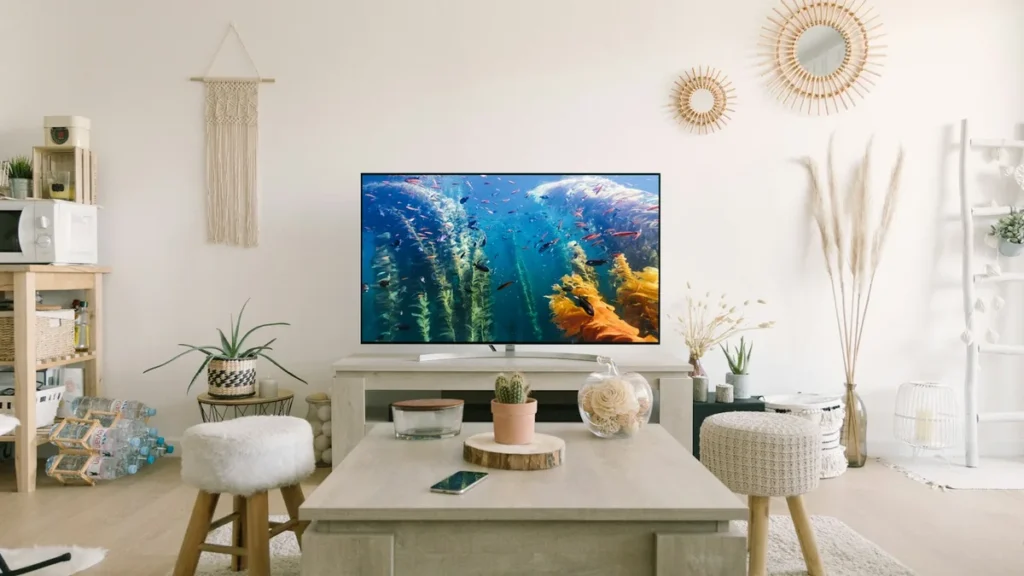 4K TV showing a colourful underwater scene in a bright living room, ready for a Firestick 4K
