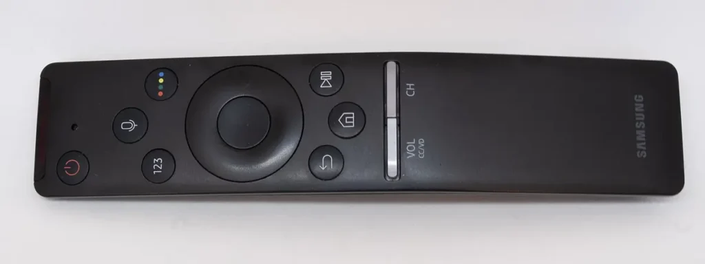 Samsung smart TV remote with home button and navigation pad, used to find and install apps for IPTV on Samsung TV